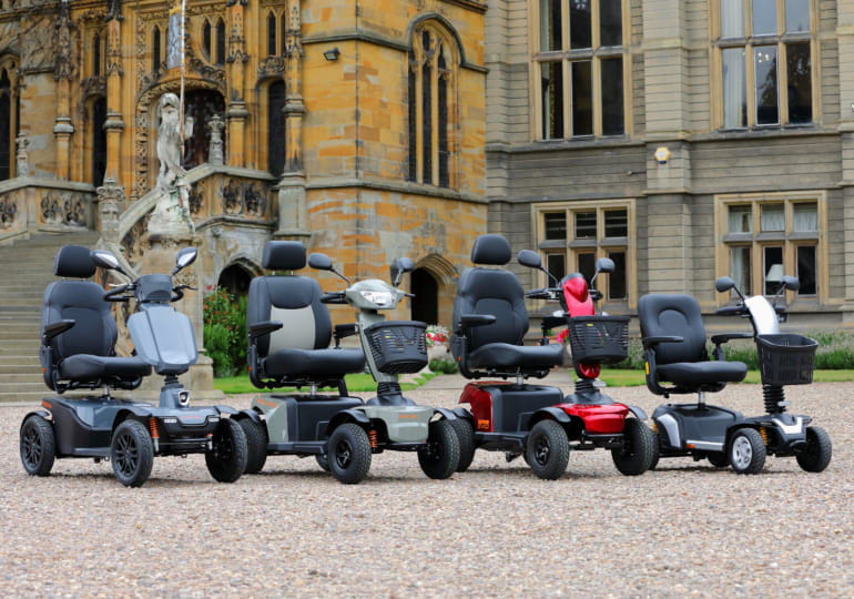 A row of Excel powered mobility scooters including the Galaxy II, Galaxy Compact II EVO and Excel Move